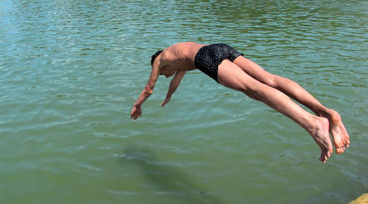 swimmer diving into water