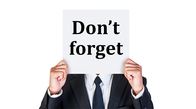 Man holding sign saying don't forget!