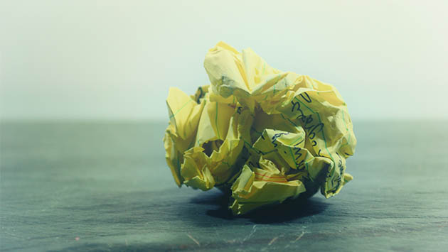 yellow sheet of paper crumpled into a ball